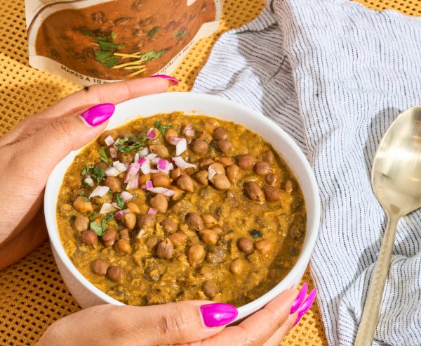 Bowl of Chana Masala held in two hands