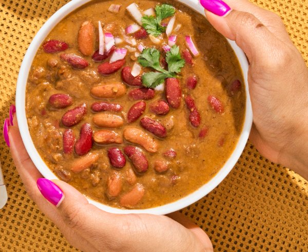 Bowl of Rajma Masala held in two hands