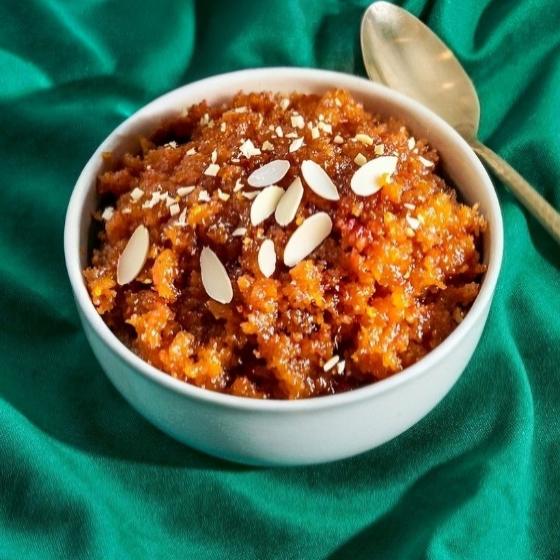 Bowl of Gajar Halwa topped with slivered almonds